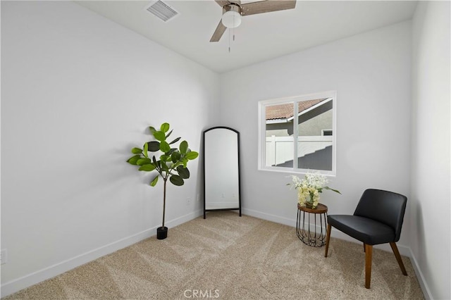 sitting room featuring light colored carpet, visible vents, ceiling fan, and baseboards