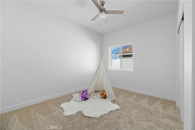 game room with carpet, baseboards, and ceiling fan