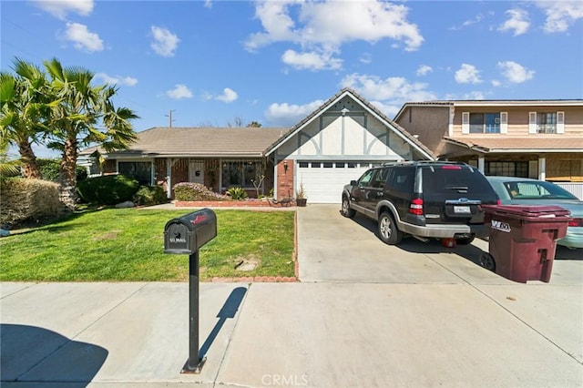 view of front of property with a garage, a front yard, brick siding, and driveway