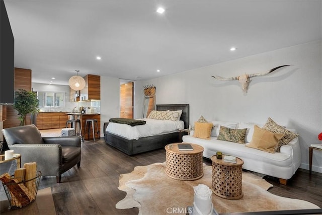 bedroom with dark wood finished floors and recessed lighting