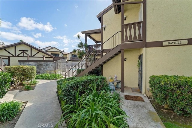 exterior space with fence and stairs