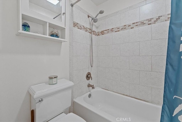 full bathroom featuring shower / bath combo with shower curtain and toilet