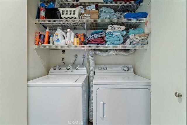 clothes washing area featuring laundry area and washing machine and dryer