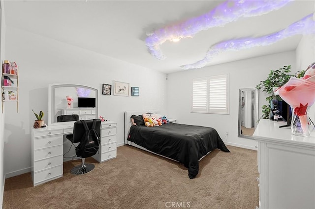 bedroom with light carpet and baseboards