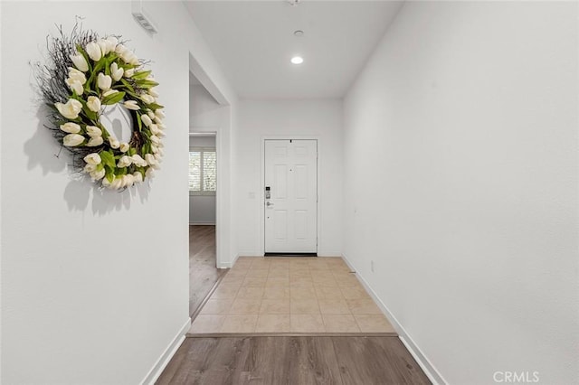 hallway with recessed lighting, light wood-type flooring, and baseboards