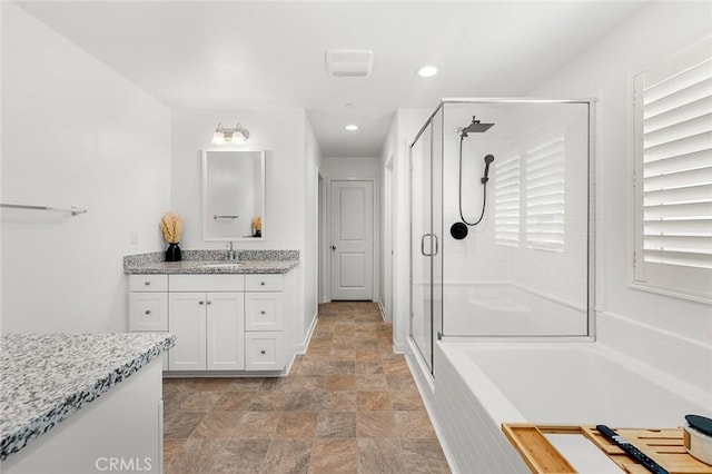 full bathroom with a garden tub, recessed lighting, stone finish flooring, vanity, and a shower stall