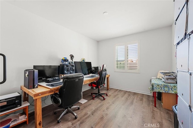 office space with light wood-style flooring and baseboards