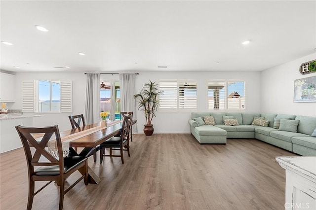 living room with plenty of natural light, light wood-style flooring, and recessed lighting