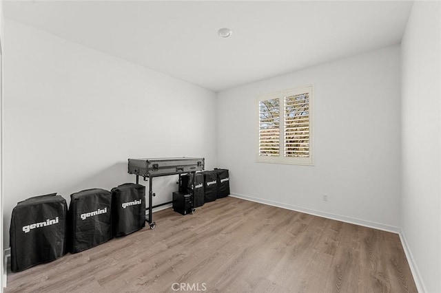 miscellaneous room featuring light wood-style floors and baseboards