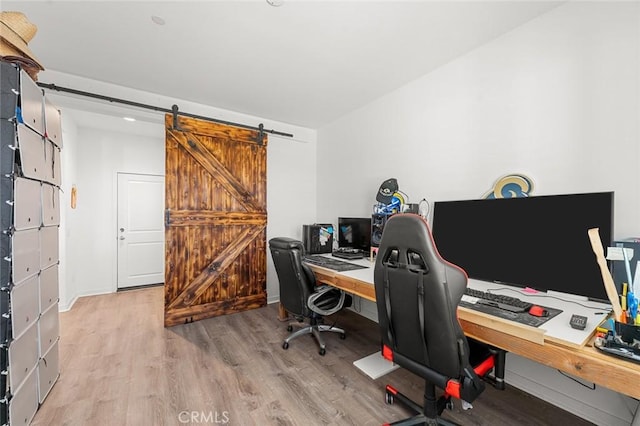 office space with light wood finished floors and a barn door