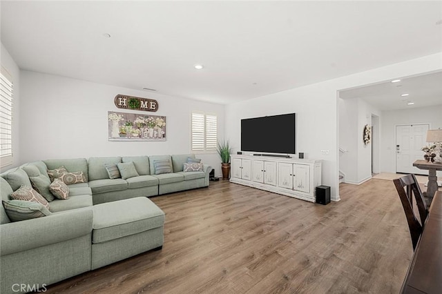 living room featuring light wood-style flooring and recessed lighting