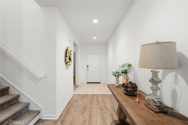 doorway to outside with stairs, baseboards, light wood-style flooring, and recessed lighting