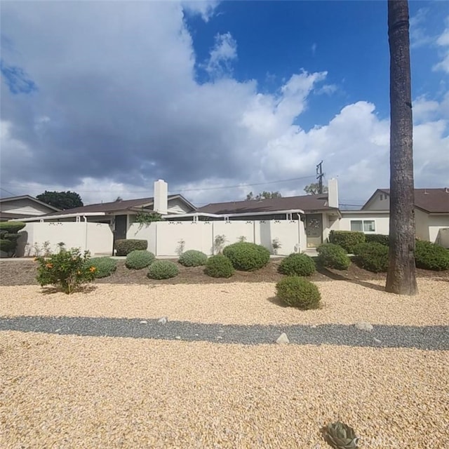 single story home featuring fence