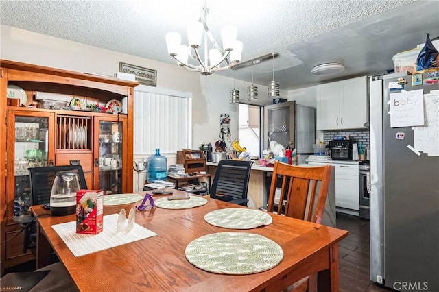 607 S Indian Hill Blvd Unit A, Claremont, CA 91711 - dining space featuring a textured ceiling, a chandelier, and dark wood-type flooring