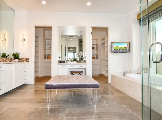 75851 Via Pisa, Indian Wells, CA 92210 - bathroom featuring a garden tub, built in shelves, a walk in closet, and vanity
