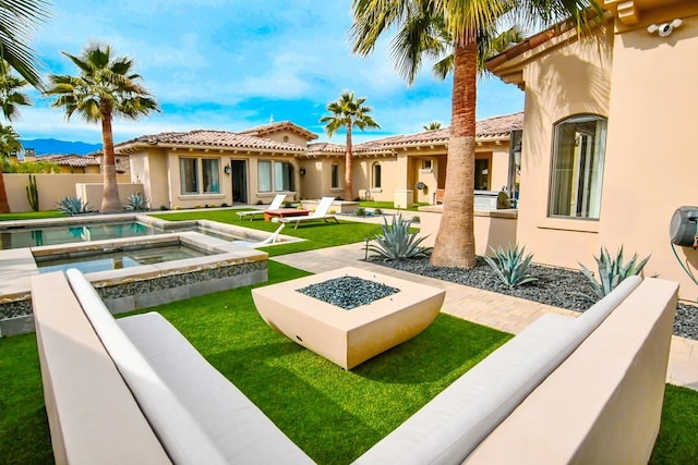 75851 Via Pisa, Indian Wells, CA 92210 - back of property with a patio area, a fire pit, stucco siding, and an in ground hot tub