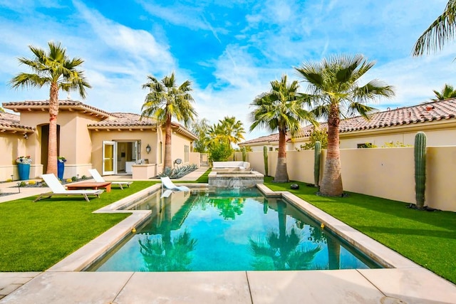 75851 Via Pisa, Indian Wells, CA 92210 - view of pool featuring a fenced backyard, a pool with connected hot tub, and a lawn