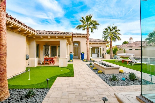 75851 Via Pisa, Indian Wells, CA 92210 - rear view of house featuring a tiled roof, a patio area, fence, and stucco siding