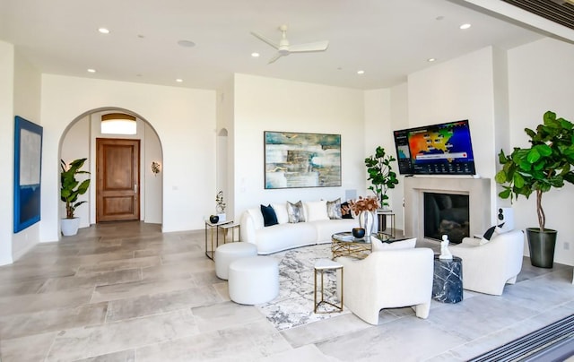 75851 Via Pisa, Indian Wells, CA 92210 - living area with a glass covered fireplace, ceiling fan, arched walkways, and recessed lighting