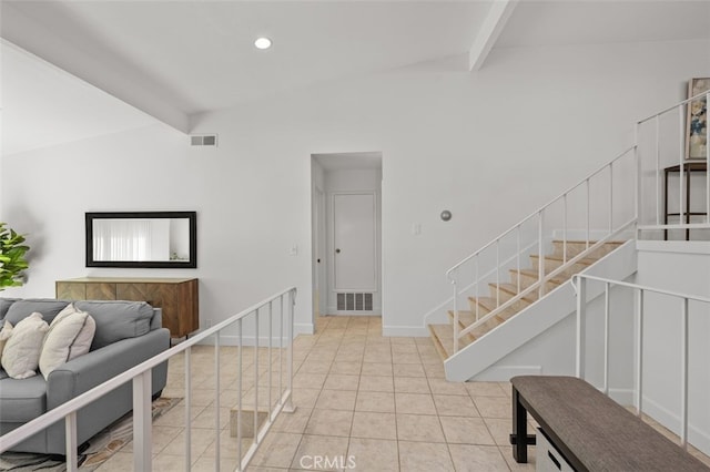 interior space with light tile patterned floors, stairway, visible vents, and baseboards