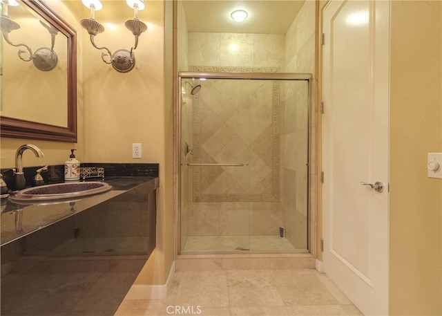 full bathroom featuring a shower stall, vanity, and baseboards