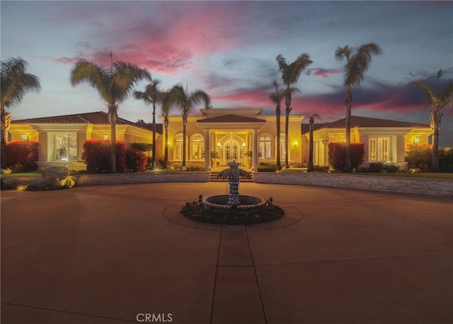 view of front of house with curved driveway