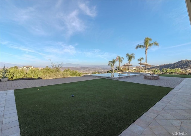 37305 Calle De Lobo, Murrieta, CA 92562 - view of green lawn featuring a patio, a pool, and a mountain view