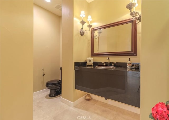 bathroom with toilet, tile patterned flooring, baseboards, and vanity