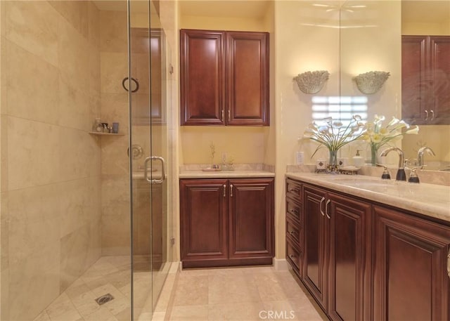 bathroom with a shower stall and vanity