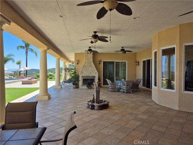 37305 Calle De Lobo, Murrieta, CA 92562 - view of patio / terrace featuring an outdoor stone fireplace, ceiling fan, outdoor dining area, and an outdoor pool