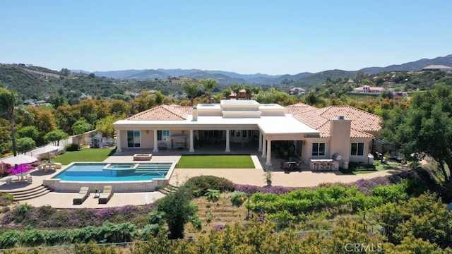 37305 Calle De Lobo, Murrieta, CA 92562 - rear view of house with a chimney, a patio area, a mountain view, and stucco siding