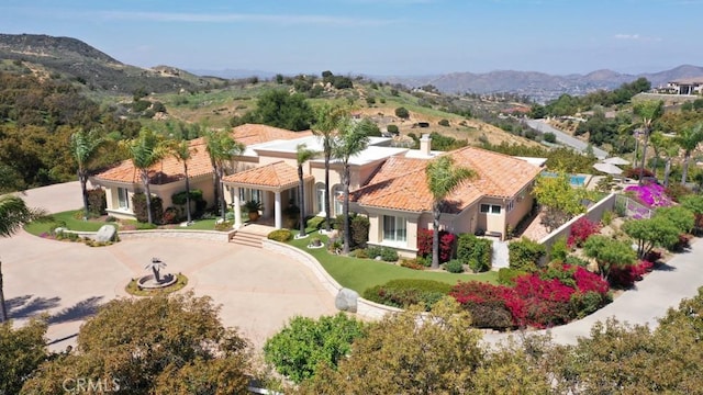 37305 Calle De Lobo, Murrieta, CA 92562 - view of front of home with a mountain view, curved driveway, stucco siding, and a tile roof
