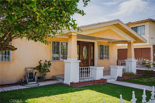 view of front of house featuring a front yard and stucco siding