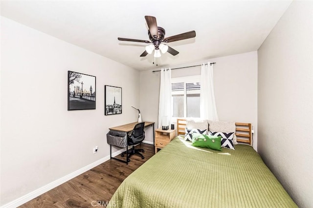 bedroom with ceiling fan, baseboards, and wood finished floors