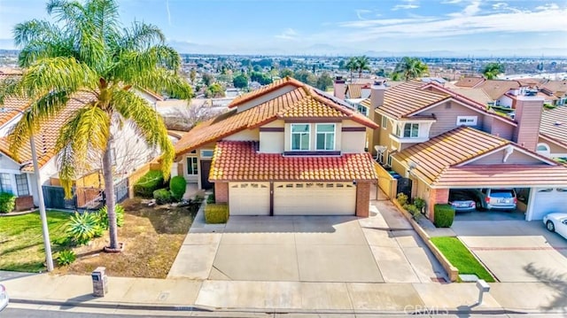 view of front of house featuring an attached garage, a tiled roof, driveway, a residential view, and stucco siding