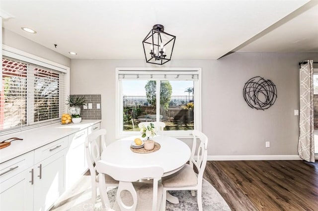 dining space featuring a chandelier, recessed lighting, dark wood finished floors, and baseboards