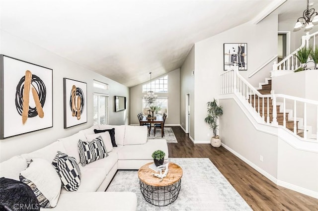 living room with dark wood-style floors, stairs, vaulted ceiling, and a notable chandelier