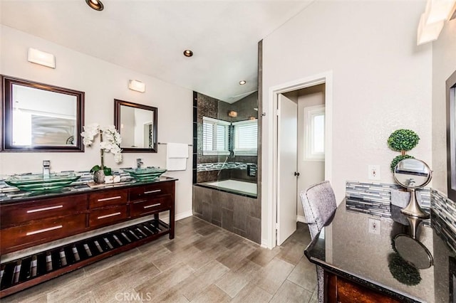 full bathroom with wood finished floors, vanity, a bath, and recessed lighting