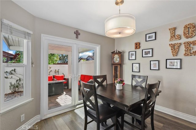 dining room with dark wood finished floors and baseboards