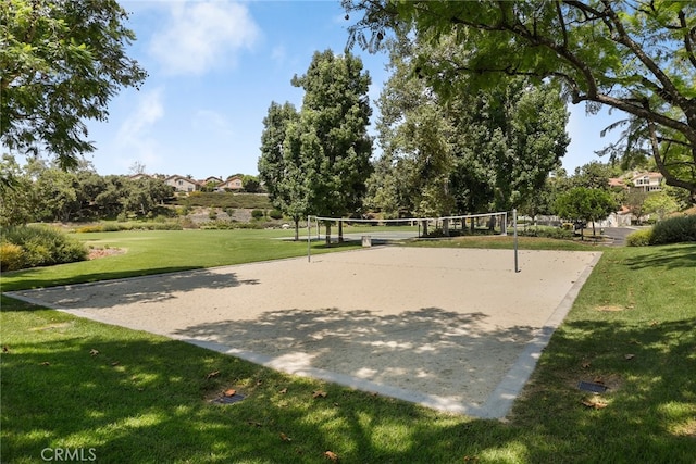 view of property's community with volleyball court and a lawn