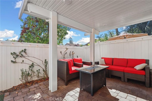 view of patio with a fenced backyard and an outdoor living space with a fire pit