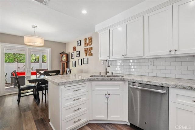 kitchen with a sink, white cabinets, stainless steel dishwasher, tasteful backsplash, and decorative light fixtures