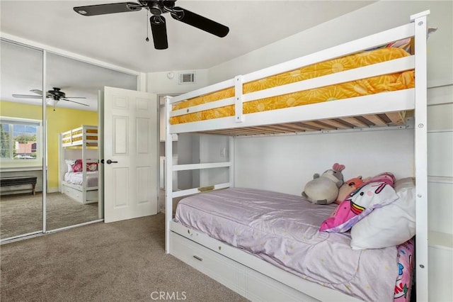 carpeted bedroom featuring a ceiling fan, a closet, and visible vents