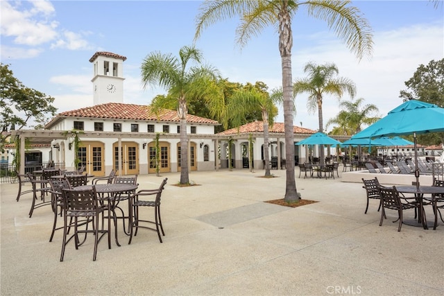 exterior space with french doors, a tile roof, and a patio