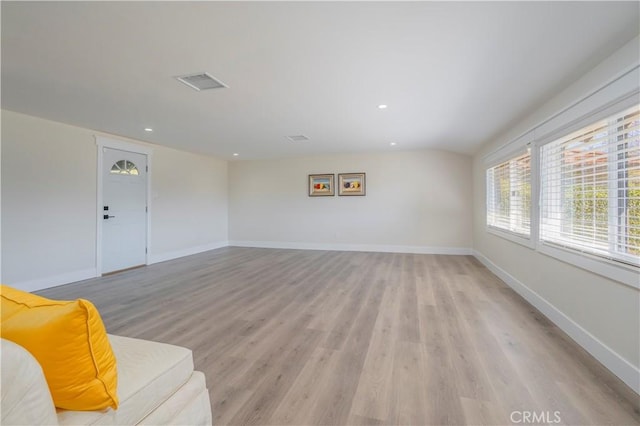 unfurnished living room featuring light wood-style floors, visible vents, baseboards, and recessed lighting