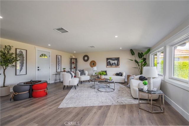 living room featuring recessed lighting, visible vents, baseboards, and wood finished floors