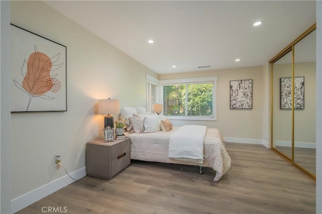 bedroom featuring recessed lighting, light wood-type flooring, and baseboards