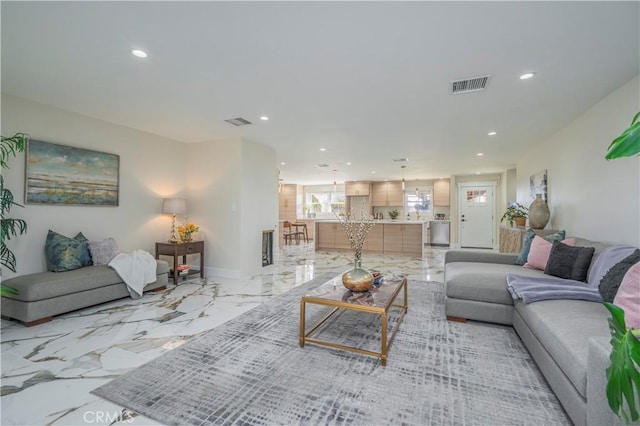 living area with marble finish floor, visible vents, and recessed lighting