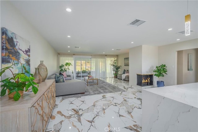 living area featuring recessed lighting, marble finish floor, visible vents, and a multi sided fireplace