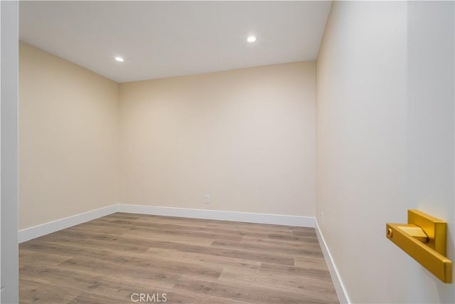 spare room with recessed lighting, wood finished floors, and baseboards